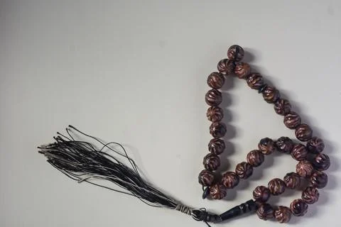 Close up view of brown prayer beads on white background. Stock Photos