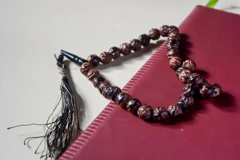 Close up view of brown prayer beads on white background. Stock Photos