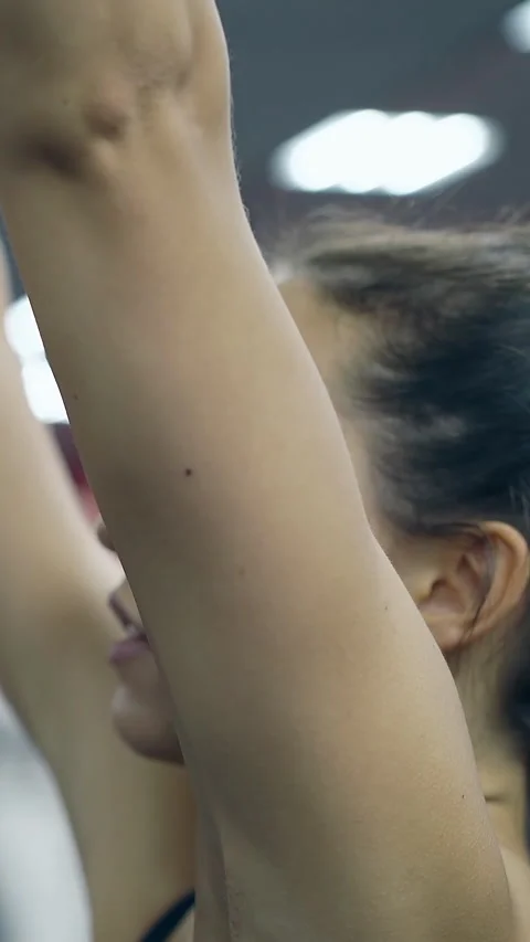 Close view brunette girl does hand excercises on handle rack Video stock 308011981