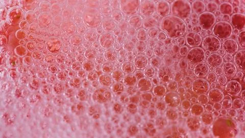Close up view of bubbles in a fizzy drink served in a clear glass on a sunny Stock Photos