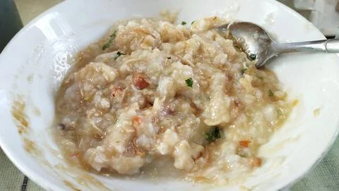 Close up view Bubur Ayam or Chicken Porridge that has been mixed with shred.. Stock Photos