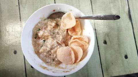 Close up view Bubur Ayam or Chicken Porridge that has been mixed with shred.. Stock Photos