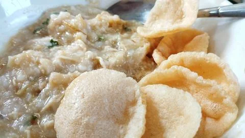Close up view Bubur Ayam or Chicken Porridge that has been mixed with shred.. Stock Photos