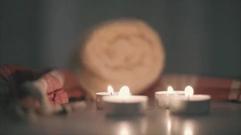 Close-up view of burning candles and towels on marble platform in Turkish bath Video stock 208394296