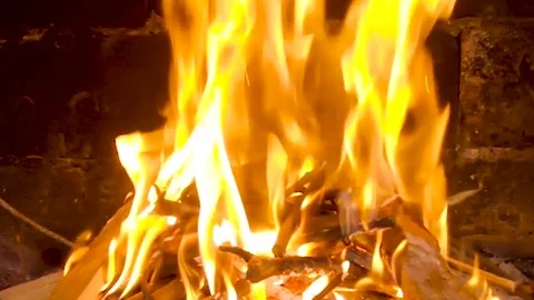 Close-up view of a burning fire with shiny flames at zooming out of the camera Stock Footage 107923193
