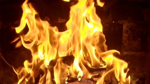 Close-up view of a burning fire with shiny flames at zooming out of the camera Stock Footage 107923574