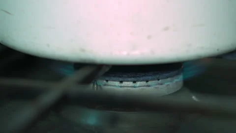 Close Up View of a Burning Kitchen Gas Stove Burner with Blue Flame Stock Footage 339647040