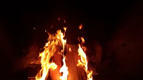 Close view on burning wood in the fireplace. Slow motion. Black background, warm Stock Footage 224518201