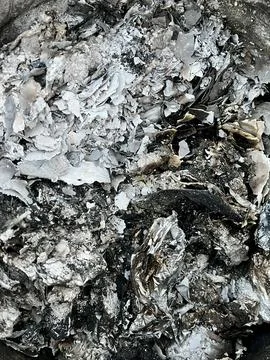 Close up view of burnt paper ash and charred remains from a fire bonfire Stock Photos