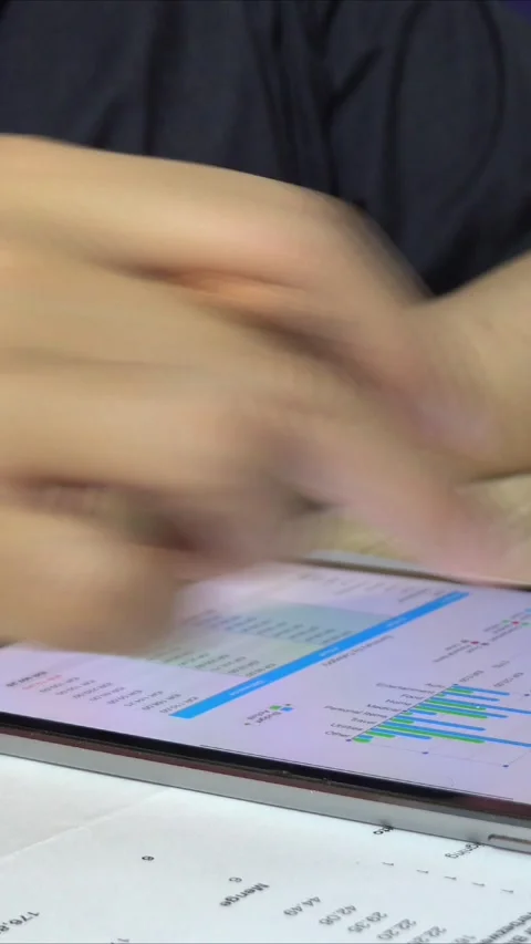 Close-up view of a businessman looking at graphs on a tablet Stock Footage 296789618