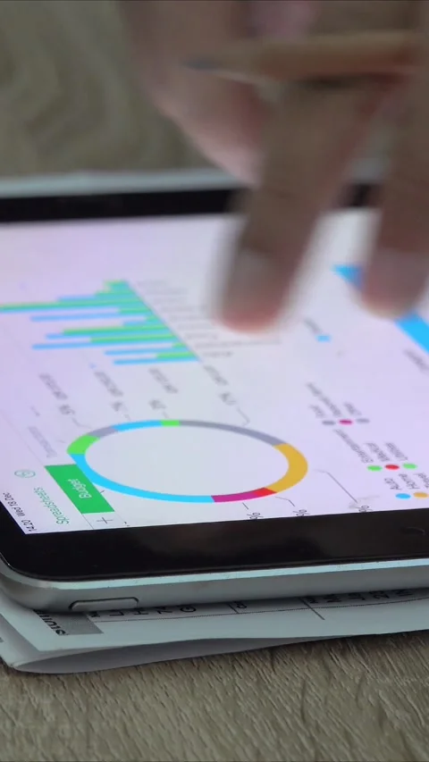 Close-up view of a businessman looking at graphs on a tablet Stock Footage 296789869