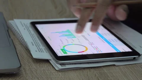 Close-up view of a businessman looking at graphs on a tablet. Stock Footage 296789993