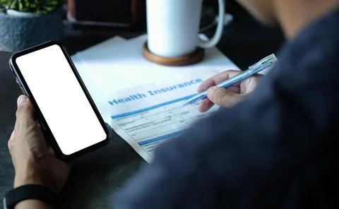 Close up view businessman using smart phone and checking financial reports. Foto stock