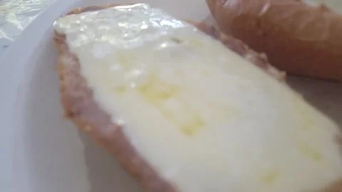 Close-Up View of Buttery Bread Slice Evoking Warmth and Comfort Stock Footage 322736671