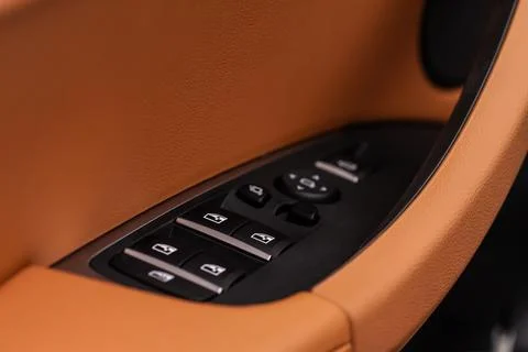 Close up view of button controlling window in modern car interior. Vehicle in Photos
