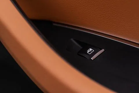 Close up view of button controlling window in modern car interior. Vehicle in Photos