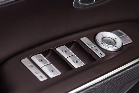 Close up view of button controlling window in modern car interior. Vehicle in Photos