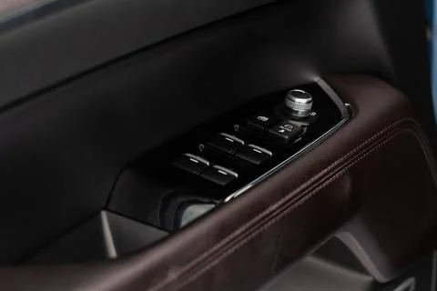 Close up view of button controlling window in modern car interior. Vehicle in Stock Photos