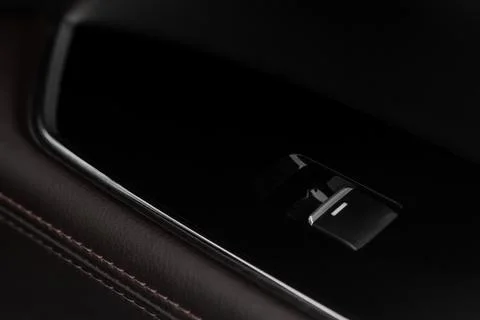 Close up view of button controlling window in modern car interior. Vehicle in Stock Photos