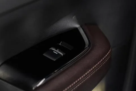 Close up view of button controlling window in modern car interior. Vehicle in Stock Photos