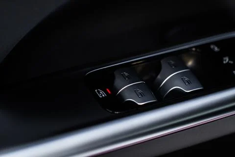 Close up view of button controlling window in modern car interior. Vehicle in Stock Photos