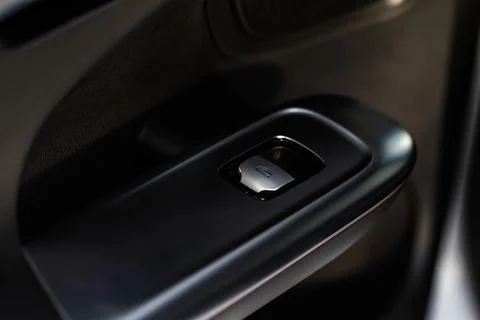 Close up view of button controlling window in modern car interior. Vehicle in Stock Photos