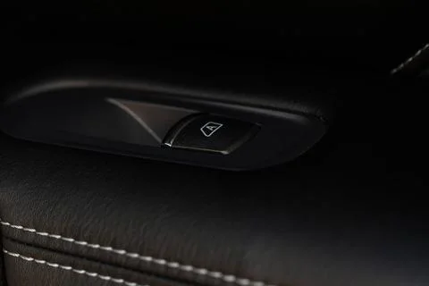 Close up view of button controlling window in modern car interior. Vehicle in Stock Photos