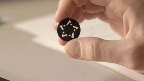 Close up view of a button from a shirt with pattern in the shape of a star Stock Photos
