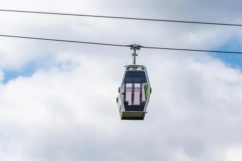 Close View of Cable Car Cabin Suspended Under Clouds Stock Photos