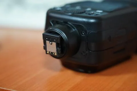 Close-up view of a camera flash attachment on a wooden table Foto stock