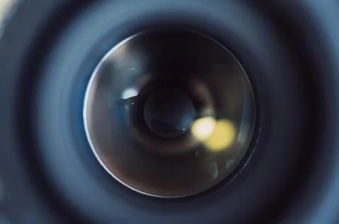 Close-Up View of a Camera Lens with Reflections and Soft Bokeh Lights Stock Photos