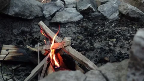 A close-up view of a campfire burning in the evening at a campsite Stock Footage 283600179
