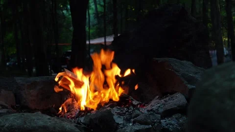 A close-up view of a campfire burning in the evening at a campsite Stock Footage 283601172