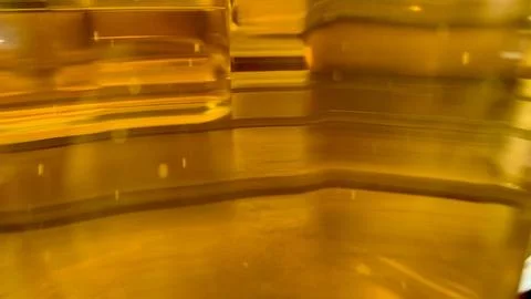 A close-up view captures the captivating play of light on a golden liquid. The Stock Photos