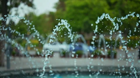 A close-up view captures water droplets suspended in mid-air as they arc fr... Stock Footage 339306740