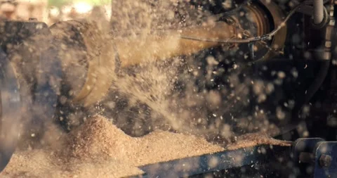 The close-up view captures the wood chipper in action, revealing a yellow Stock Footage 279992998