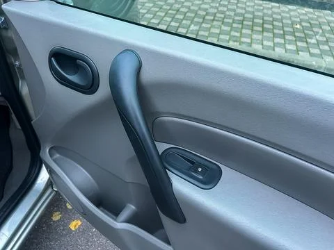 Close view of a car door handle and window control in a parking area during.. Stock Photos