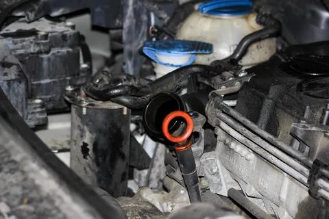 Close-up view of a car engine compartment showing an oil dipstick with an o.. Fotos Stock