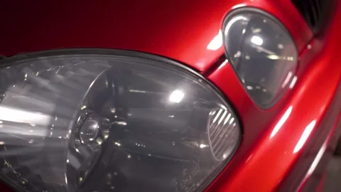 Close up view of car headlamp of car. Footage. Red spotrs auto hood, glass 스톡 동영상 145187219
