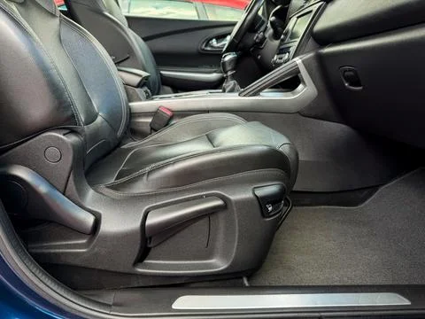 Close view of a car interior showing a driver s seat with controls and a cl.. Stock Photos