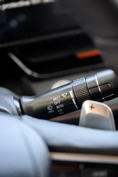 Close up view of car light switch control. Headlight switch, turn signal leve Stock Photos