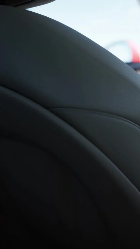 Close view of a car seat showing black leather and stitching details Stock Footage 337997408