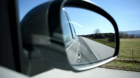 Close up view of car side mirror during highway drive Stock Footage 104776395