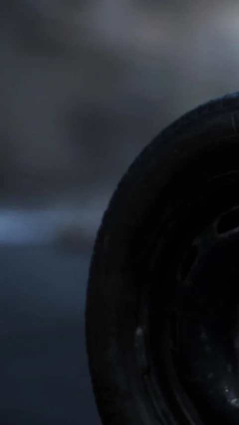Close view of a car tire on a road during early morning light Stock Footage 342153302