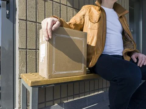 Close view of cardboard box placed on bench shows purchase and delivery con.. Stock Photos