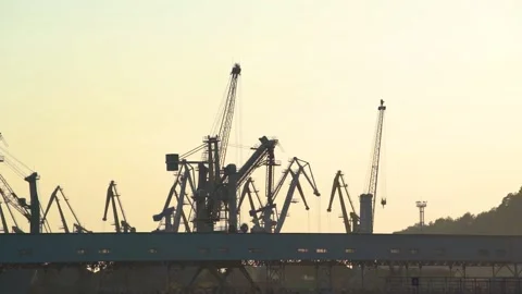 Close up view of cargo cranes and heavy lift, warehouse on bright morning sky. Stock Footage 136653877