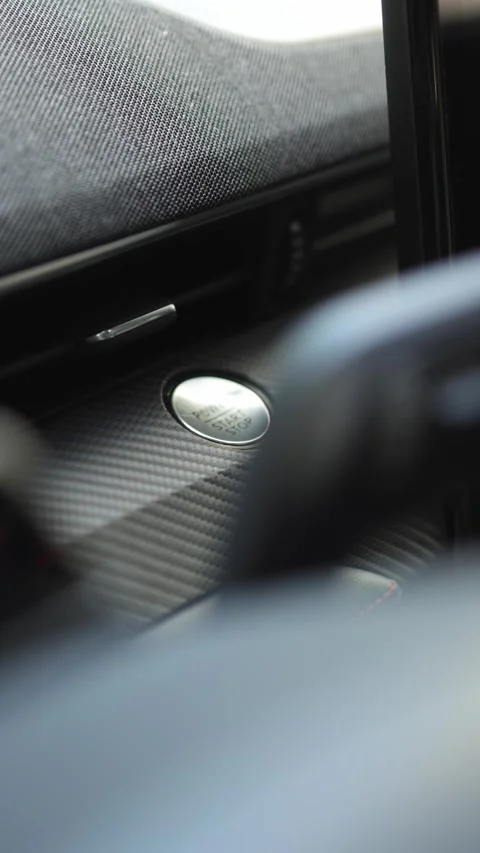 Close-up view of a car's ignition button and dashboard details, showcasing the Stock Footage 337386183