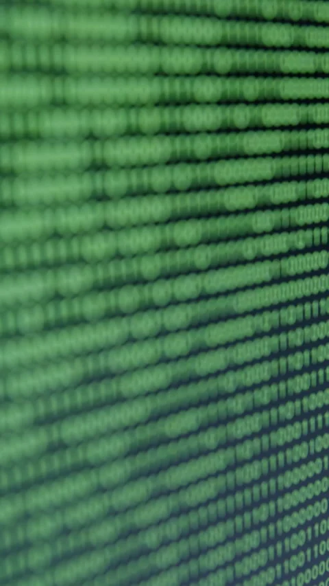 Close-up view of cascading binary code on a digital screen, showcasing a hacker Stock Footage 323744063