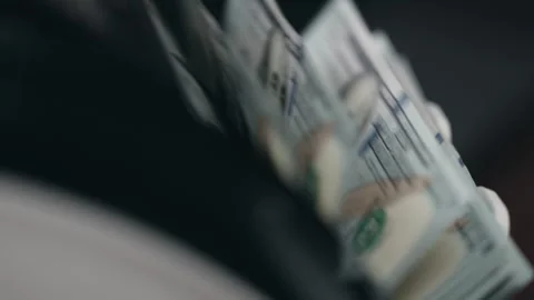 Close-up view of cash being handled, showcasing a stack of hundred-dollar bills Stock Footage 331080170