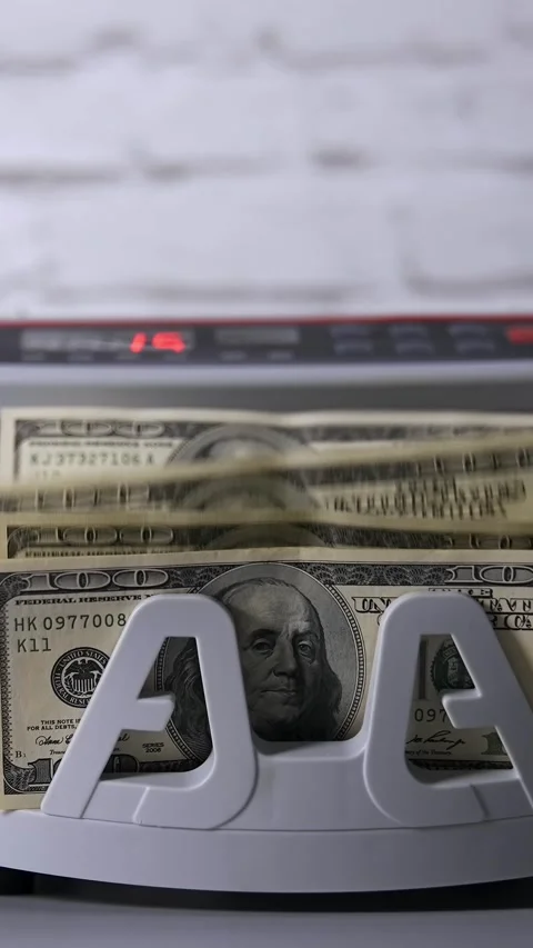 A close up view of cash counting machine processing hundred dollar bills dy.. Stock Footage 337634853